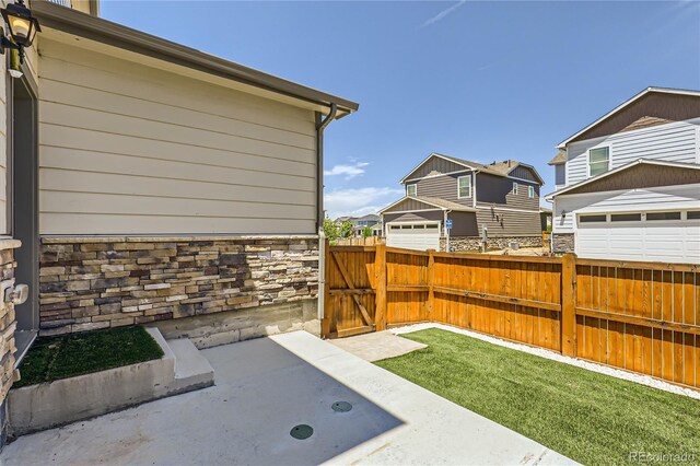 764 N Quatar St, Aurora, CO 80018 - view of yard with a gate, a residential view, and a garage