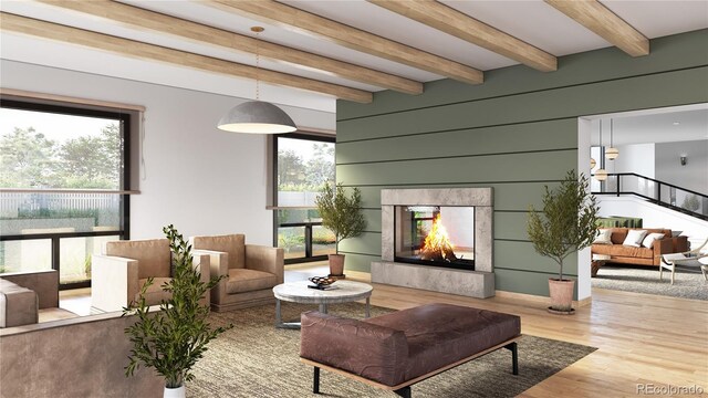 living room featuring hardwood / wood-style flooring, beamed ceiling, and a premium fireplace