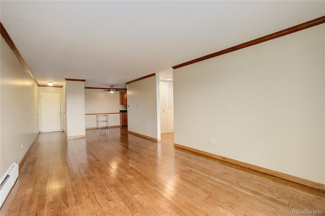 spare room featuring light hardwood / wood-style flooring, a baseboard radiator, ornamental molding, and ceiling fan