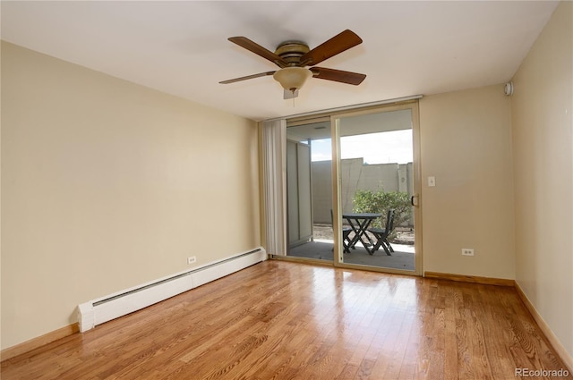 empty room featuring floor to ceiling windows, light wood-type flooring, ceiling fan, and baseboard heating