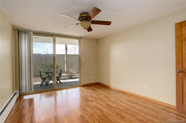 unfurnished room with ceiling fan, light hardwood / wood-style flooring, baseboard heating, and a wall of windows