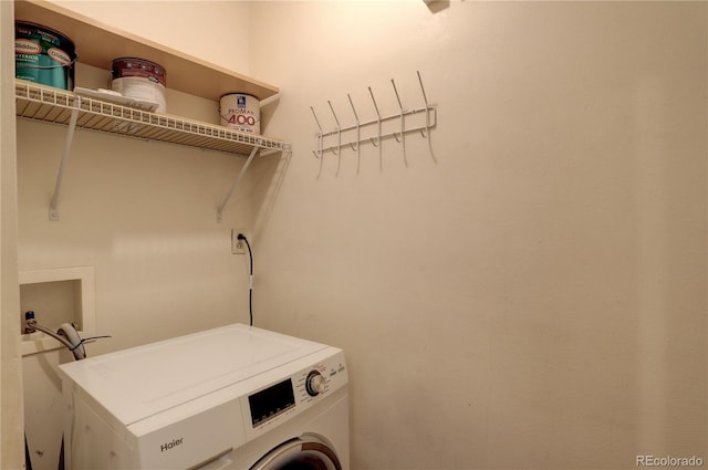 clothes washing area with washer / dryer