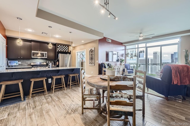 dining area with ceiling fan, recessed lighting, light wood-style flooring, and visible vents