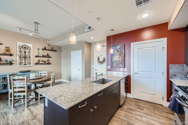 2001 Lincoln St Unit 2213, Denver, CO 80202 - kitchen featuring a sink, appliances with stainless steel finishes, light wood finished floors, hanging light fixtures, and open shelves