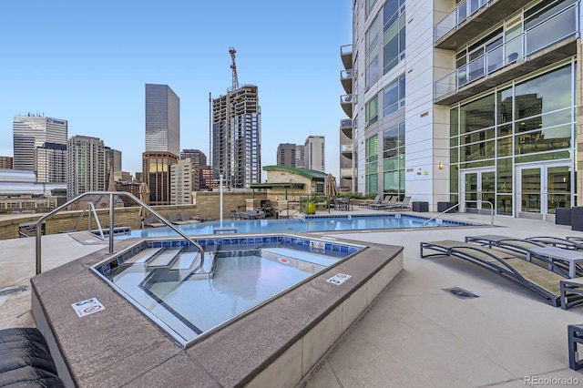 2001 Lincoln St Unit 2213, Denver, CO 80202 - view of swimming pool with a community hot tub, a skyline view, and a patio area