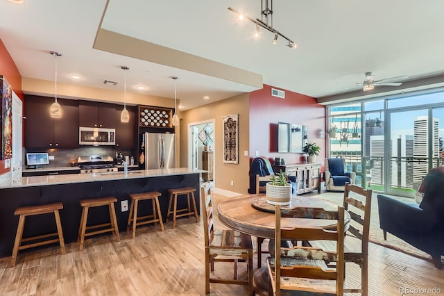 2001 Lincoln St Unit 2213, Denver, CO 80202 - dining space with light wood-style flooring, a ceiling fan, recessed lighting, and baseboards