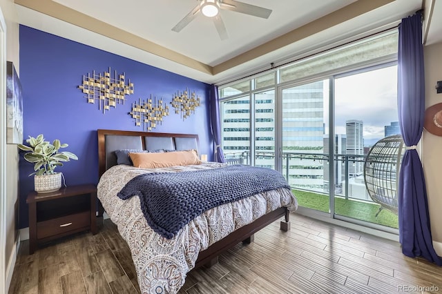 2001 Lincoln St Unit 2213, Denver, CO 80202 - bedroom with access to exterior, wood finish floors, a ceiling fan, and a city view