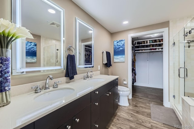 2001 Lincoln St Unit 2213, Denver, CO 80202 - full bath featuring a shower stall, a walk in closet, wood finished floors, and recessed lighting