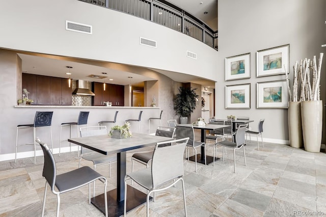 2001 Lincoln St Unit 2213, Denver, CO 80202 - dining space with baseboards, light marble finish floors, and a high ceiling