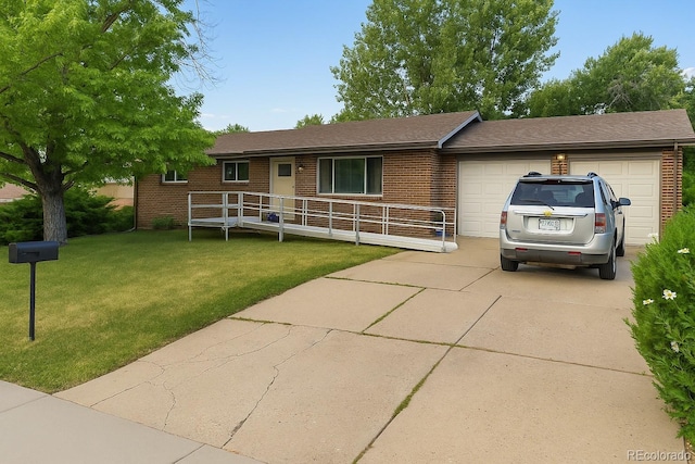 7121 Pierce St, Arvada, CO 80003 - ranch-style house with brick siding, concrete driveway, an attached garage, and a front yard
