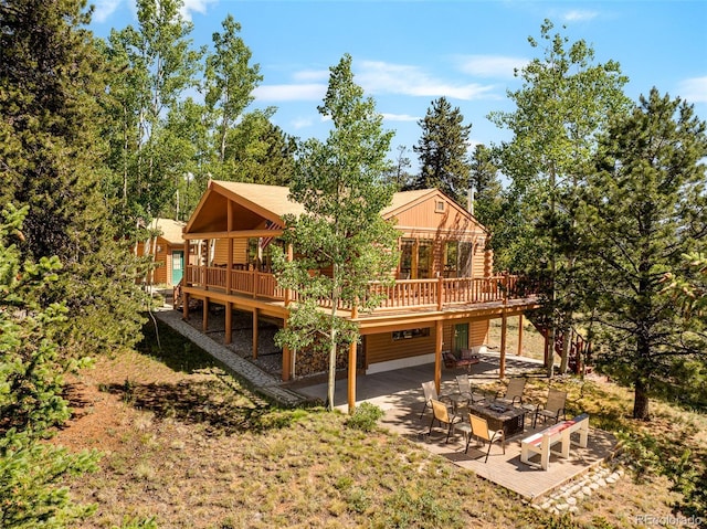 142 Summit Way, Bailey, CO 80421 - rear view of property with a deck, a fire pit, a patio area, board and batten siding, and log siding