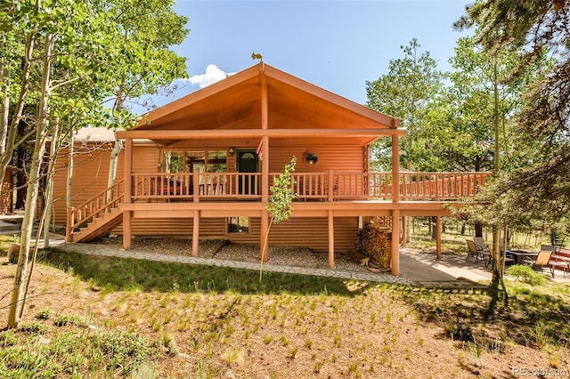 142 Summit Way, Bailey, CO 80421 - back of property featuring a deck, a patio area, stairs, and log veneer siding
