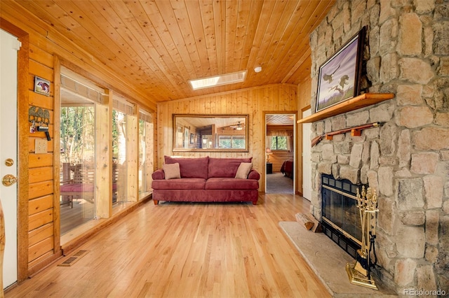 142 Summit Way, Bailey, CO 80421 - living area featuring wooden walls, lofted ceiling, wood finished floors, healthy amount of natural light, and wood ceiling