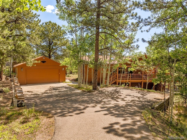 142 Summit Way, Bailey, CO 80421 - view of front of home featuring an outdoor structure, a detached garage, and driveway