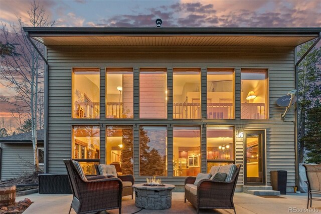 381 Highlands Dr, Bailey, CO 80421 - rear view of property featuring an outdoor living space with a fire pit and a patio