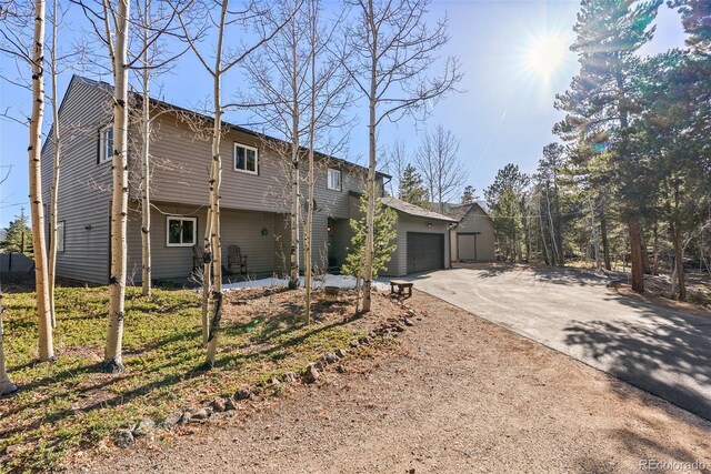 381 Highlands Dr, Bailey, CO 80421 - view of front of property featuring driveway and a garage