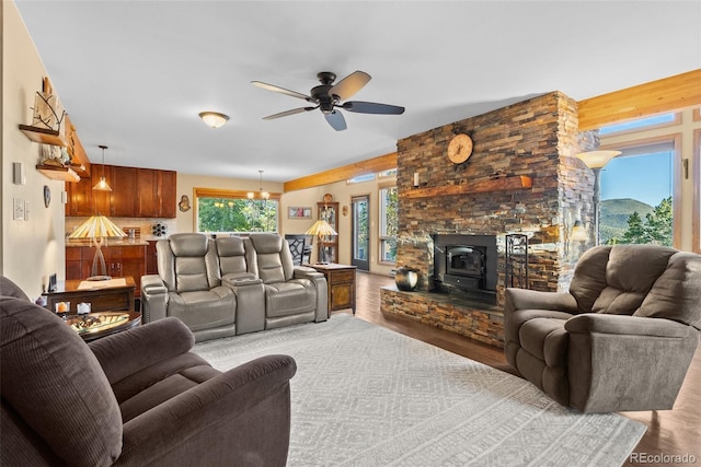 381 Highlands Dr, Bailey, CO 80421 - living area with a wood stove, a ceiling fan, and wood finished floors