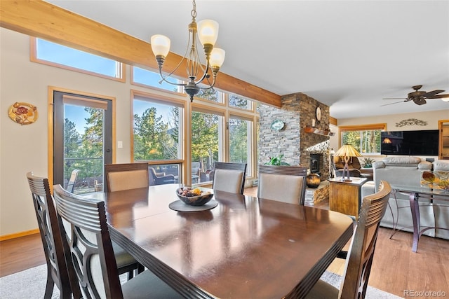 381 Highlands Dr, Bailey, CO 80421 - dining room featuring light wood-style floors, a fireplace, and ceiling fan with notable chandelier