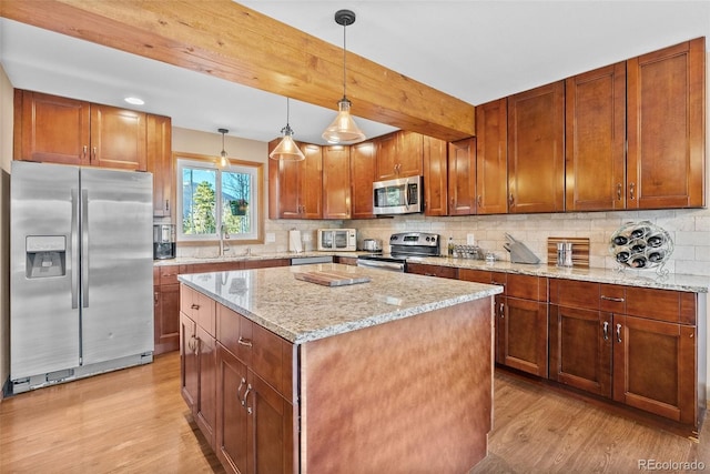 381 Highlands Dr, Bailey, CO 80421 - kitchen with a sink, stainless steel appliances, light wood-type flooring, backsplash, and a center island