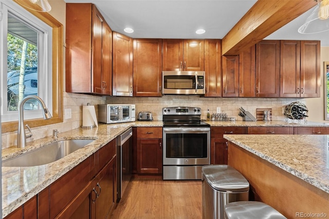 381 Highlands Dr, Bailey, CO 80421 - kitchen featuring light wood finished floors, a sink, a toaster, stainless steel appliances, and tasteful backsplash