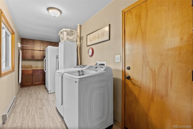 381 Highlands Dr, Bailey, CO 80421 - laundry room featuring laundry area, light wood-style flooring, a baseboard radiator, and washing machine and clothes dryer