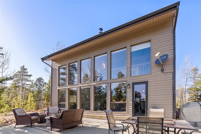 381 Highlands Dr, Bailey, CO 80421 - back of house featuring a patio and an outdoor living space