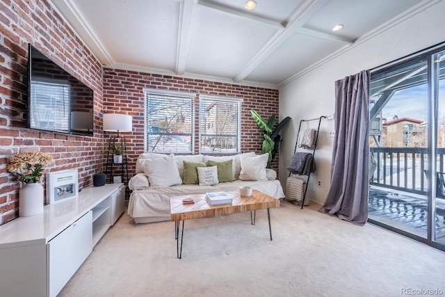 living room with beamed ceiling, light carpet, a healthy amount of sunlight, and brick wall
