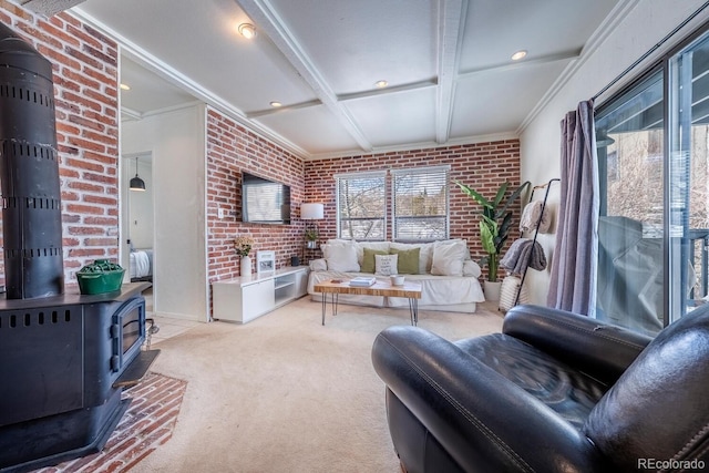 carpeted living area with beam ceiling, coffered ceiling, a wood stove, ornamental molding, and brick wall