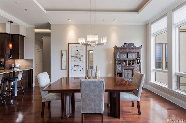 dining space featuring a raised ceiling, crown molding, a fireplace, and dark hardwood / wood-style flooring