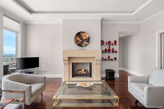 living room with a tray ceiling, dark hardwood / wood-style floors, and crown molding