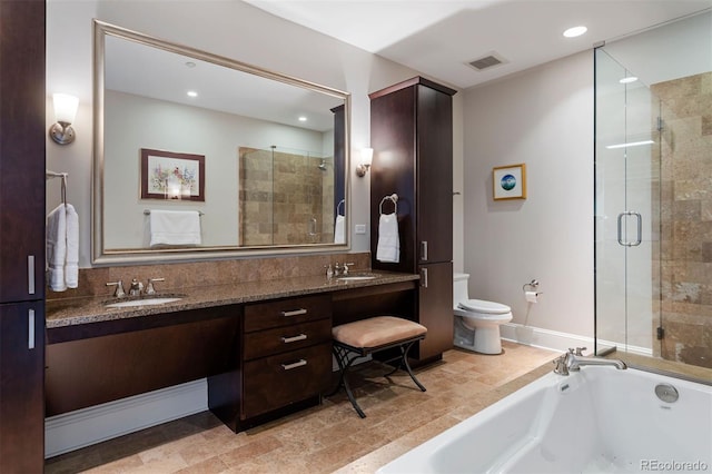 full bathroom featuring toilet, vanity, and separate shower and tub