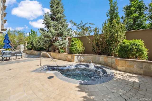 view of pool featuring pool water feature and a patio area