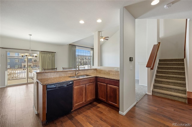 kitchen featuring light stone countertops, black dishwasher, sink, and kitchen peninsula