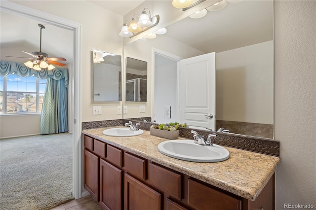 bathroom with ceiling fan, vanity, vaulted ceiling, and tile patterned floors