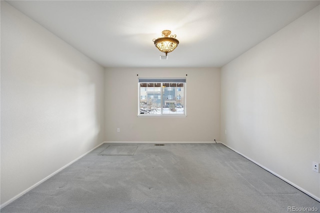 unfurnished room with light colored carpet