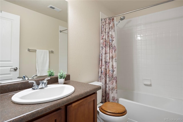 full bathroom with vanity, shower / tub combo, and toilet