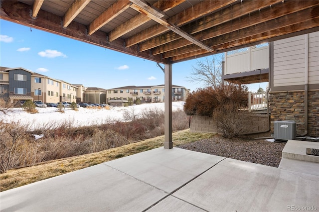 snow covered patio with central air condition unit