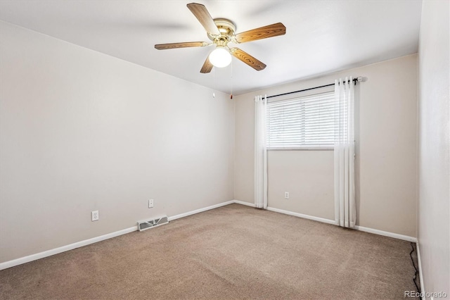 empty room featuring a ceiling fan, carpet, visible vents, and baseboards