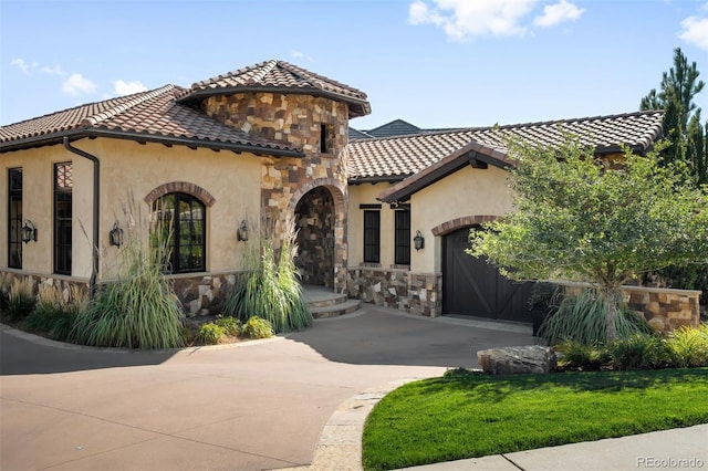 mediterranean / spanish-style home with a garage