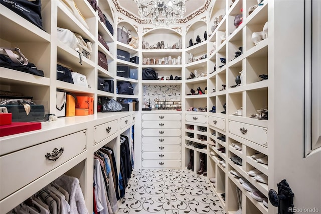 walk in closet featuring an inviting chandelier