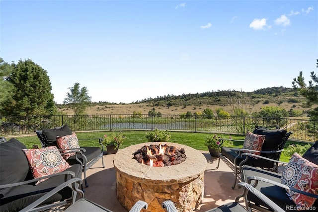 view of patio / terrace with an outdoor fire pit and a rural view