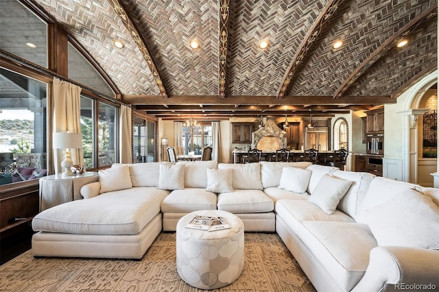 living room featuring brick ceiling, a notable chandelier, and vaulted ceiling