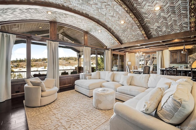 living room with brick ceiling, an inviting chandelier, lofted ceiling with beams, a water view, and light hardwood / wood-style flooring