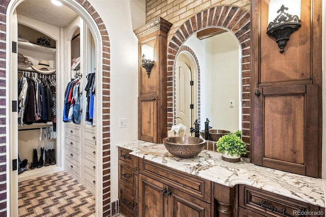 interior space with brick wall and vanity