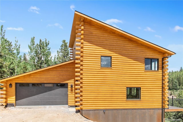 view of side of home featuring a garage