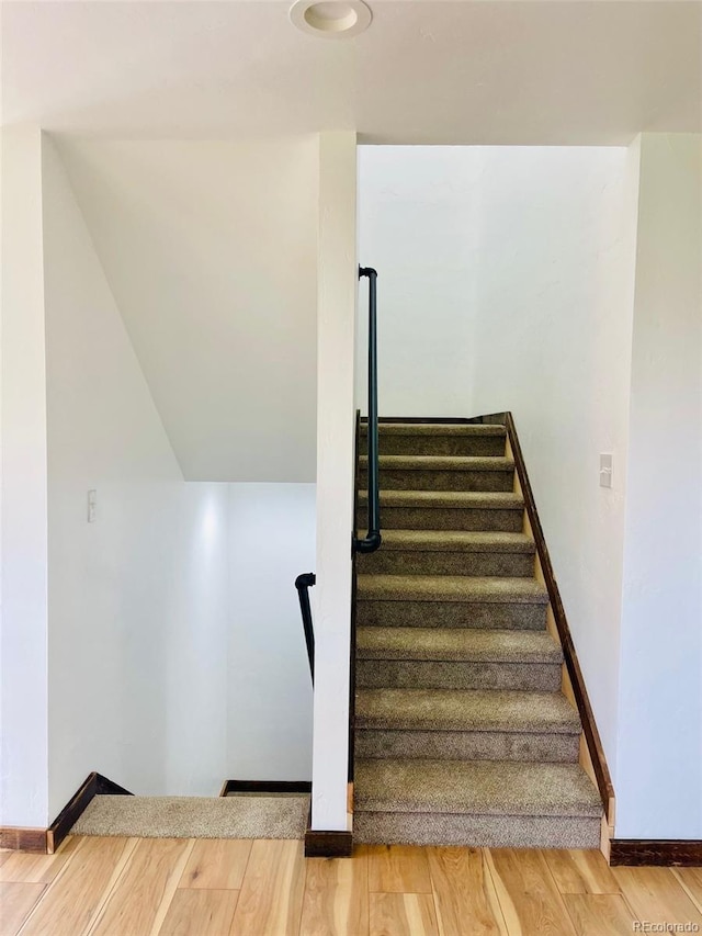 stairs featuring hardwood / wood-style flooring