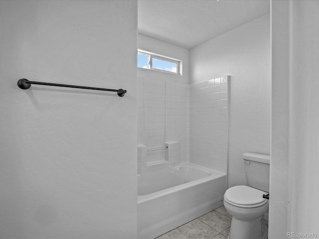 full bath with a textured wall, tile patterned flooring, and toilet
