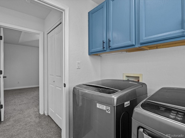 laundry area featuring washing machine and dryer, carpet floors, and cabinet space