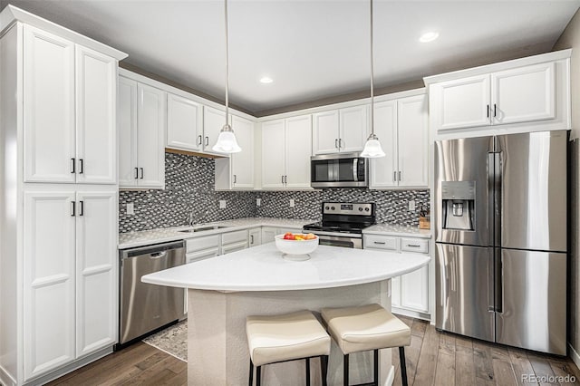 kitchen featuring a sink, stainless steel appliances, dark wood-style floors, and white cabinetry