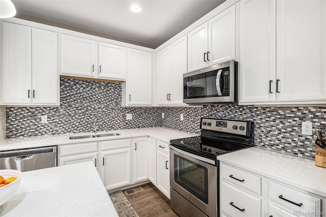 10066 Belvedere Cir, Lone Tree, CO 80124 - kitchen with stainless steel appliances, white cabinets, a sink, and wood finished floors